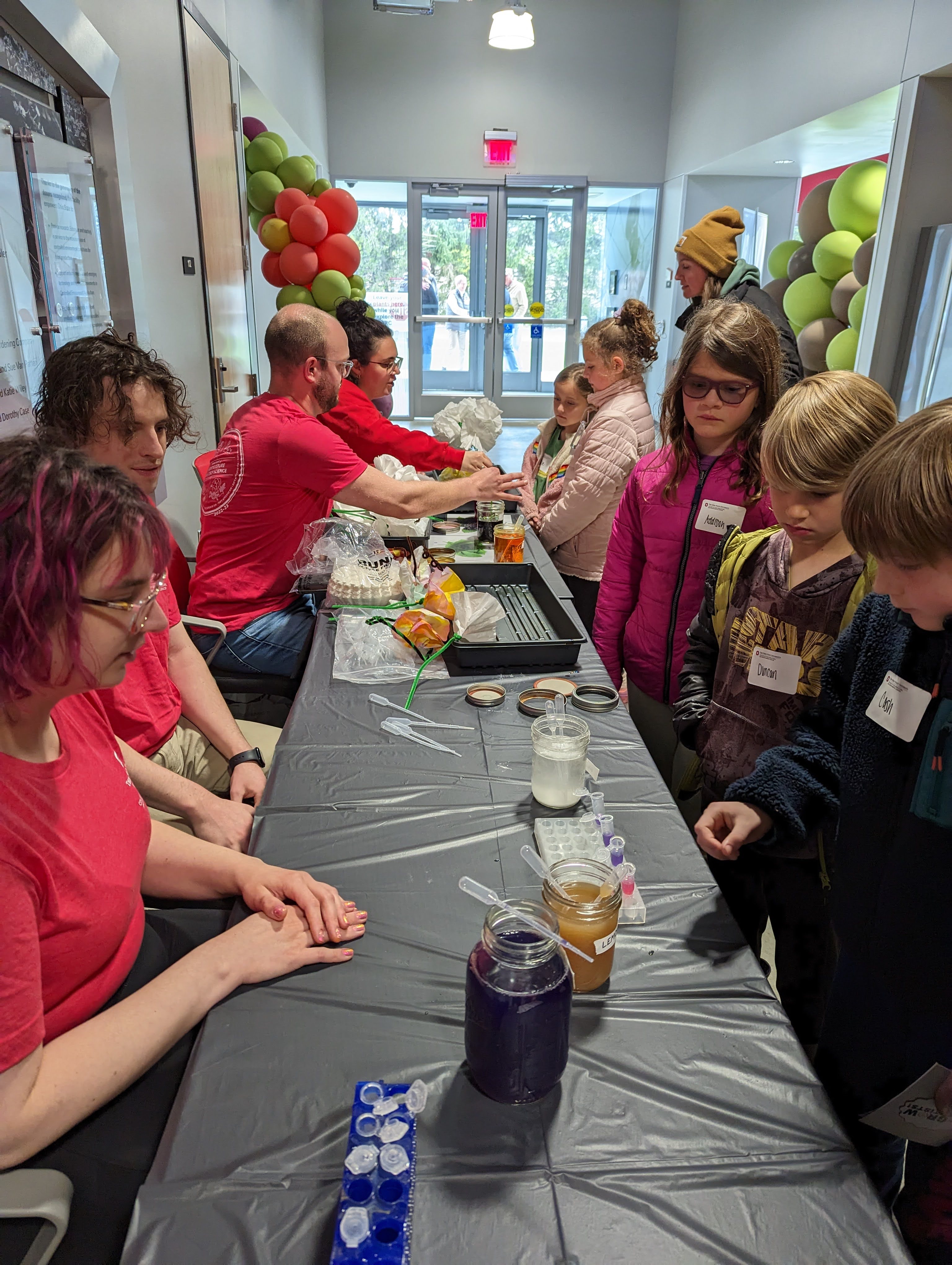 Lydia, Aaron, Matt, and Jess volunteer at We Grow Scientists 2023, with CFAES and COSI. Lydia and Aaron were teaching kids about pH using cabbage juice, lemon juice, and baking soda, and Matt and Jess were painting with natural plant pigments (from turmeric, spinach, and blackberries) on coffee filter flowers and butterflies.